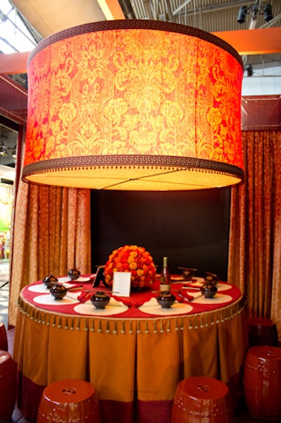 Vern Yip also went for orange with his design for Fabricut, which included an oversize, damask-patterned drum shade chandelier and a centerpiece composed of fabric flowers.