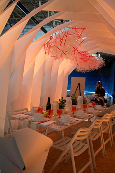 Interior design firm EDG's offering was a collapsible, portable dining unit, designed to be used as a pop-up restaurant or alongside food trucks. The chandeliers were made from plastic straws, and the table centerpieces included frosted Mason jars holding votive candles.