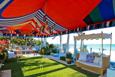 A section of the tented party space was turned into a croquet field, complete with a custom chandelier, flags, and cabana-like seating areas adorned with Hermès silk scarves.