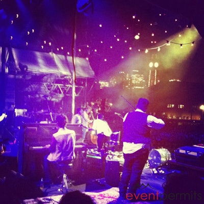 On stage with Mumford & Sons as the group plays