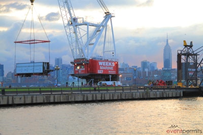 Crane on Hudson River barge lifts stage onto Pier A