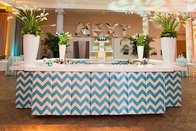 Organizers moved the main bar upstairs on the bridge of the atrium this year, which better served the wandering dinner guests as well as the attendees of the after-hours dance party Club Corcoran hosted by the young professionals group 1869 Society. Matching current design trends, blue and white chevron linens covered the front of the four-sided bar.