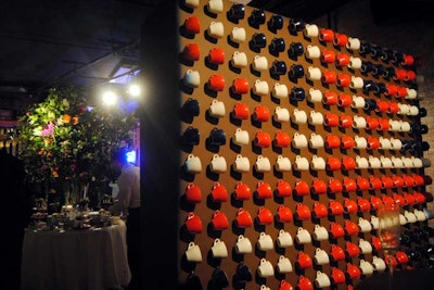 A British flag was constructed out of 256 hanging blue, red, and white teacups. The wall on which they were arranged separated the Worship Street Whistling Shop bar and the Mad Hatter's Tea room, which offered tastes of the popular tea brand and small bites from Luna & Curious.