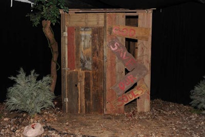 As guests neared a creaky shack within The Walking Dead section, the structure began to rattle violently with actor zombies trapped inside. A traveling party of survivors led the event's attendees through the forest, resecuring affixed chains to the shack as they passed.