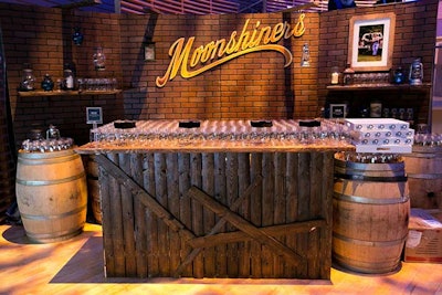 A homespun bar, complete with Mason jars and white whiskey cocktails, promoted the show Moonshiners.
