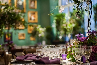 Low-lying jasmine floral arrangements, purple votives, and plum linens added spots of color to the indoor garden ambience.