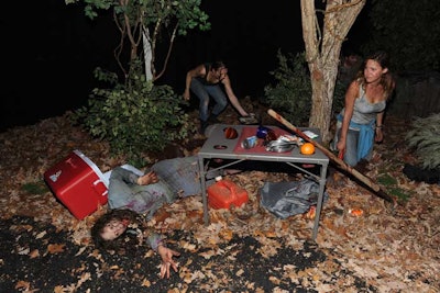 An abandoned campsite in the middle of a dense, fog-covered forest was created to evoke The Walking Dead. Blood and limbs were scattered in the area, while actors played straggling zombies. The organizers arranged the experiential tour in a way that meant every guest had to pass through The Walking Dead vignette and at least one other setup before reaching the central space.