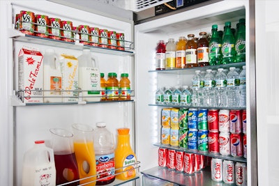 A fully-stocked beverage refrigerator with waters, sodas and juices.