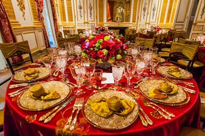 The Salon Doré is the most inherently opulent of all the galleries with its gilded walls. Working with that inspiration, Perfect Settings provided red linens with sheer overlays and ornately decorated gold chargers and flatware.