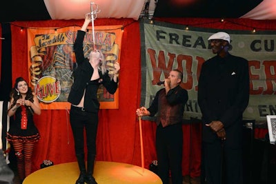 A gaudy, red velvet big-top tent showcased reality series Freakshow. To create the mystery of a circus sideshow, eclectic furnishings and old carnival-style banners were placed amidst small stages playing host to exotic characters and performances—including a sword swallower and tallest man in America.