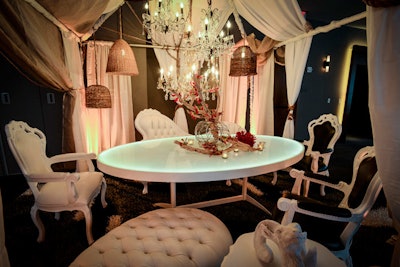 Creating a luxury cabana fit for an heiress, designers Dwayne Ridgaway and Jordan Carbotti of Perfect Surroundings used a chaise lounge, tufted ottoman, and dining chairs from CORT’s new Napoleon collection for a regal feel. A contemporary illuminated OvalGlo Dining Table, rustic basket shades with Edison bulbs, and crystal chandeliers finished the over-the-top look.
