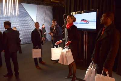 As guests exited the event, staffers in matching uniforms (their scarves matched the orange of the Range Rover Sport driven by Daniel Craig) dispensed gift bags that contained a detailed catalog of the new vehicle.