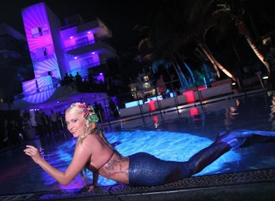 In addition to the roaming Playboy bunnies, playmates, and scantily clad dancers at Playboy's 2010 Super Bowl party in Miami, performers dressed as mermaids from Zhantra Entertainment swam in the pool and posed for pictures.