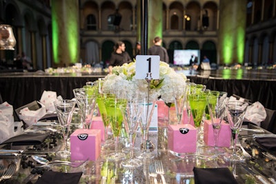 Edge Floral Event Designers kept the centerpieces minimalistic with simple arrangements of white hydrangea or floating flower petals and votives in clear vases. Georgetown Cupcake's individually wrapped cupcakes in signature pink pastry boxes added a pop of color to the tables. During the weeks leading up to the event, the bakery donated a portion of sales from its 'pupcake' cupcake to the organization.