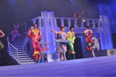 Live performers dressed in colorful costumes representing bedtime story characters in keeping with an event’s “Starry Night” theme.