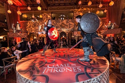 The in-the-round setup featured a stage where performers, including swordsmen and musicians, entertained guests throughout the evening.