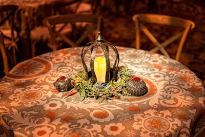 The tabletops featured patterned linens and Medieval-like centerpieces.