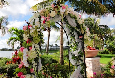 Lush florals set on an all-weather iron arch