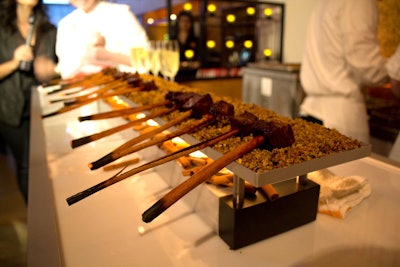 Grant Achatz served up a culinary spectacle by placing pieces of Wagyu short ribs on cinnamon sticks, then lighting the ends on fire for a fragrant touch.