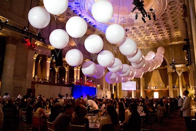 A total of 44 white PVC balloons, each anchored by nylon rope, created a dramatic backdrop to the gala's black-and-white theme. The seven-foot diameter of the balloons were exactly the same as the 55 round dinner tables.