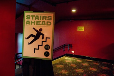 Demonstrating IFC's sense of humor, a giant instructional warning sign directing guests to the restroom and coat check reminded them to use caution while using the stairs in skates.