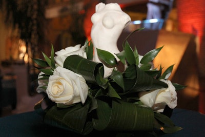 Flowers held miniature replicas of marble busts.