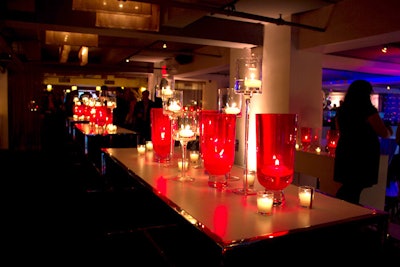 Candles housed inside red hand-blown glass torchieres and stemmed clear glass votives dominated the decor.
