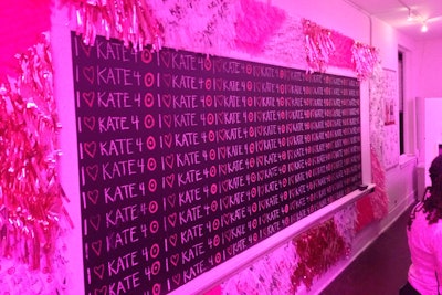 Along one wall of the Kate Young for Target pop-up shop was a chalkboard with a tongue-in-cheek interpretation of the brand's logo surrounded by pink, red, and white streamers.