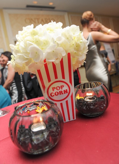 Fluffy white flowers spilled out of striped containers that were shaped like classic popcorn boxes.