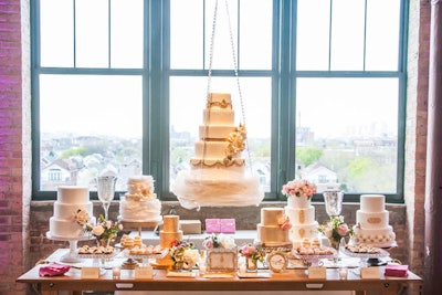 Several vendors set up ornate sweets tables. A display from Elysia Root Cakes held gilded, tiered confections, vintage props, and flowers from Ashland Addison Florist.