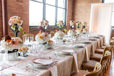 Revel Decor also designed a tabletop, bringing in pale pink linens, crystal stemware, and plenty of roses.