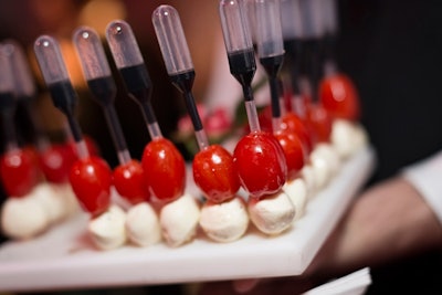 Playful menu items included cherry bocconcini with grape tomatoes with individual tubes of balsamic vinaigrette. Liberty Grand Entertainment Complex handled the catering.