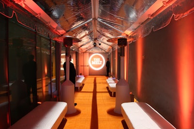 Grand entrance with orange carpet, climate control heaters, tent, custom gobo projection, modern furniture & lighting.