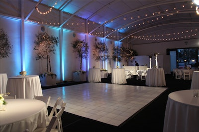 White dance floor, black carpet, tables & chairs, climate control, bar and lighting.