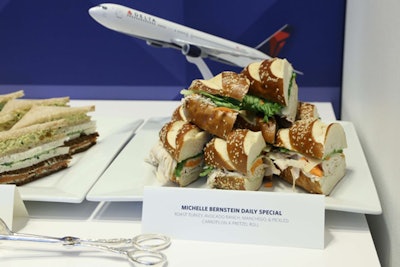 Chef Michelle Bernstein, who crafted the BusinessElite menu on flights to South America, created the T4X menu. The dishes were inspired by Delta's most popular international routes from J.F.K., including Paris, Athens, Amsterdam, Mexico City, and San Juan. A daily special sandwich had roast turkey, manchego cheese, pickled carrots, and avocado ranch on a pretzel roll.