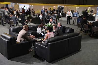Organizers expanded the Executive Meeting Center, a destination for scheduled meetings between SAP customers and hosts. The area includes a mix of lounge seating, conference tables, and enclosed rooms around the perimeter.