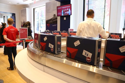 Pop-up shoppers could buy food from a themed counter. A flight information screen displayed the day's selections of sandwiches and salads, and a conveyor belt delivered each guest's choice in a mini cardboard Delta suitcase.