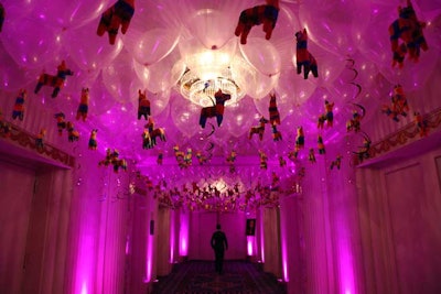 Miniature bright-colored donkey piñatas from Oriental Trading party supplies were suspended from clear balloons in the Silver Corridor, which lead guests into the Grand Ballroom for the main event.