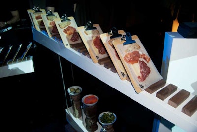 A charcuterie plate offered single-serving portions on clipboards.