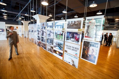 The gallery featured winning print entries in large acrylic frames suspended by aircraft cables. Using whites and simple decor, the display became the centerpiece of the room.