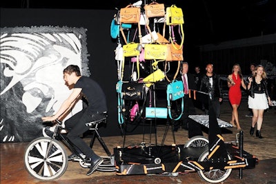 Complementing the three mini fashion shows and concerts, a pedicab sporting a rotating carousel of rainbow-colored Venus Versace bags made its way throughout the cavernous venue, offering guests the chance to hop on the back for a ride.