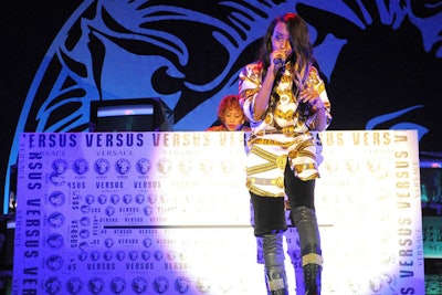 Rapper Angel Haze joined Dead Sara and Grimes in performing three songs each throughout the event, each one of their concerts timed to the debut of one-third of the Versus Versace collection. Stages, with DJ booths wrapped in Versus tape, were erected on opposite sides of the venue to eliminate any static and to keep the energy live and free-flowing.