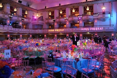 Design team Monroe Alechman and Brian Avon created the theme and carried out the design of the event. Each dinner table featured a 'fiestaware' pitcher filled with crepe paper chayo's flowers in bold colors. Alternating bright linens were provided by Cloth Connections, and, in addition to soft pink lighting, projections of the night's theme decorated the ballroom.