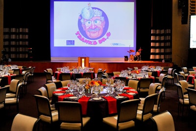 Cartoon images of the doctor appeared in the event's collateral and on a drop-down screen in the dining room. Bright red and orange daisies were provided by Young Jong Fruit & Flower Market.