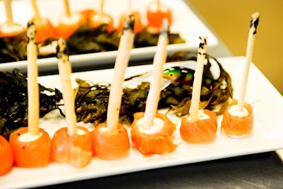 Fishy bites from 10Tation Catering included cedar-smoked salmon with goat cheese, capers, and onions wrapped around homemade breadsticks. As though washed up from the sea, the appetizers were plated beside a tangle of seaweed and a plastic fish.