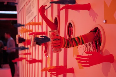 The other side of the entrance space saw a wall of hands—live hands mixed with mannequin ones—offering drinks. As an incentive to interact with all aspects of the event, guests could collect chips for activities like petting one of the animals in the FarmVille petting zoo, which could be given to the hands in exchange for small prizes.