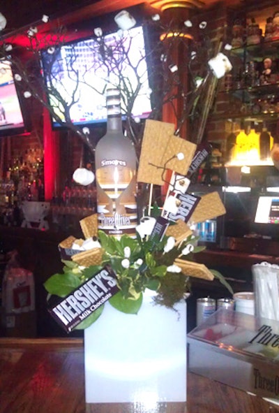 Conceptbait Global Events & Florida Design Group used real graham crackers, Hershey bars, and two sizes of marshmallows to create centerpieces at the launch party for Three Olives S’mores Vodka at Hattricks Tavern in Tampa. Designers spray-painted manzanita branches brown and used a blowtorch to char the marshmallows before attaching them to the branches.