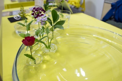 Toyko-based Oodesign's tiny floating vases hold individual buds and submerge their stems in water.