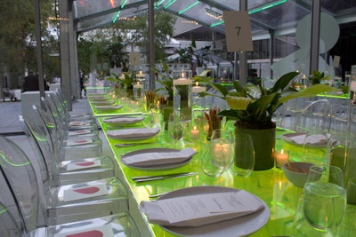 Slabs of neon green Lucite seemed to glow atop the clear rectangular dinner tables, while potted plants in green ceramic vases served as minimalist centerpieces.
