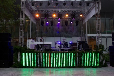 Neon tubes—interspersed with tropical foliage and ferns—also covered the front of the garden's elevated stage.